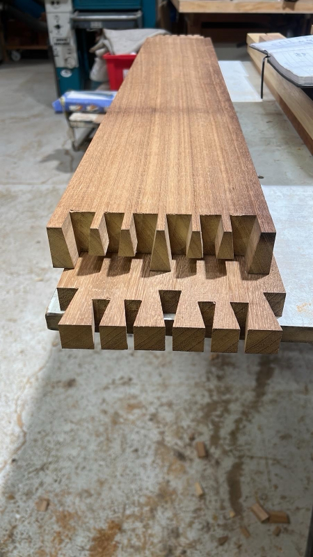 Long timber rails with traditional joinery on the workshop trestles