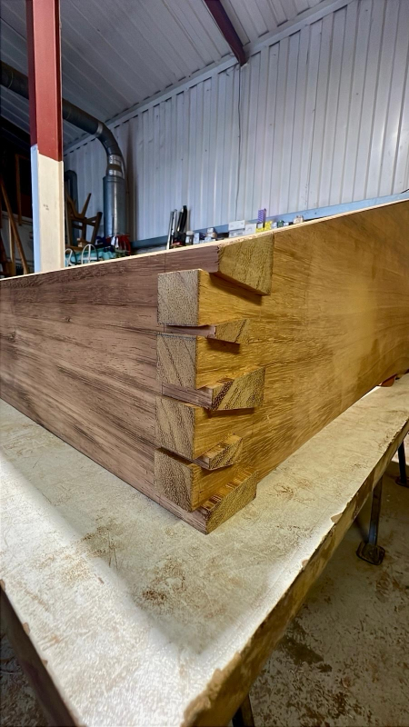 Hand-cut dovetail joints on a bespoke hardwood cabinet in the workshop